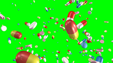 Pills and capsules falling, green screen